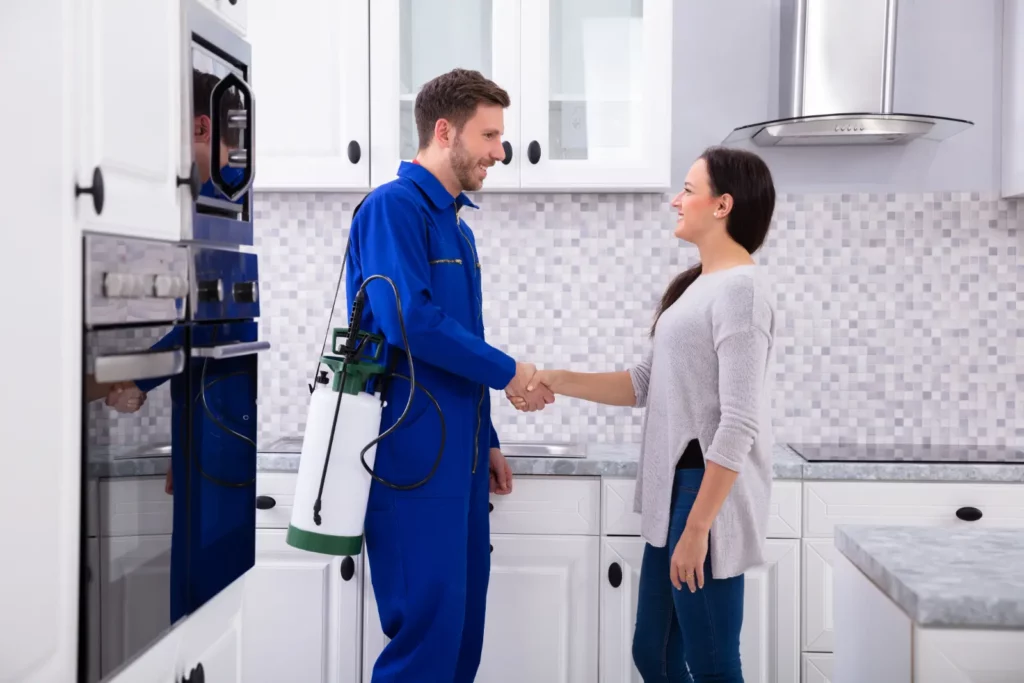 Pest Infestations. Pest Control Worker Shaking Hands With Woman