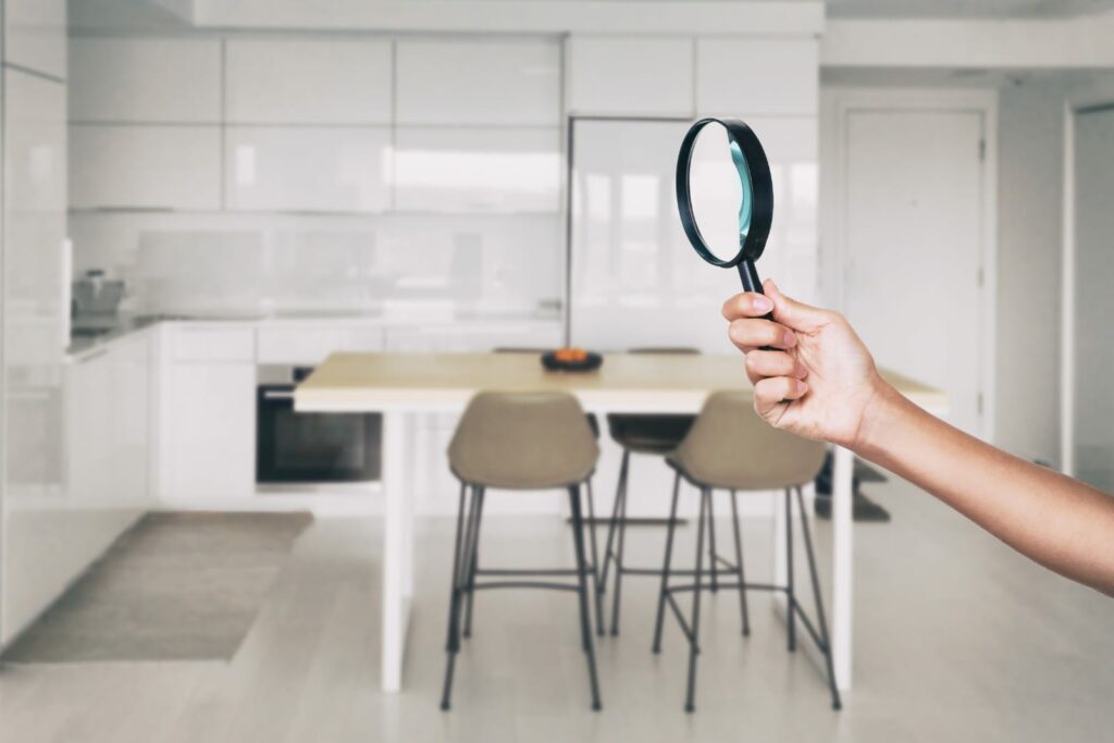 how to keep your house clean. A magnifying glass over a kitchen.